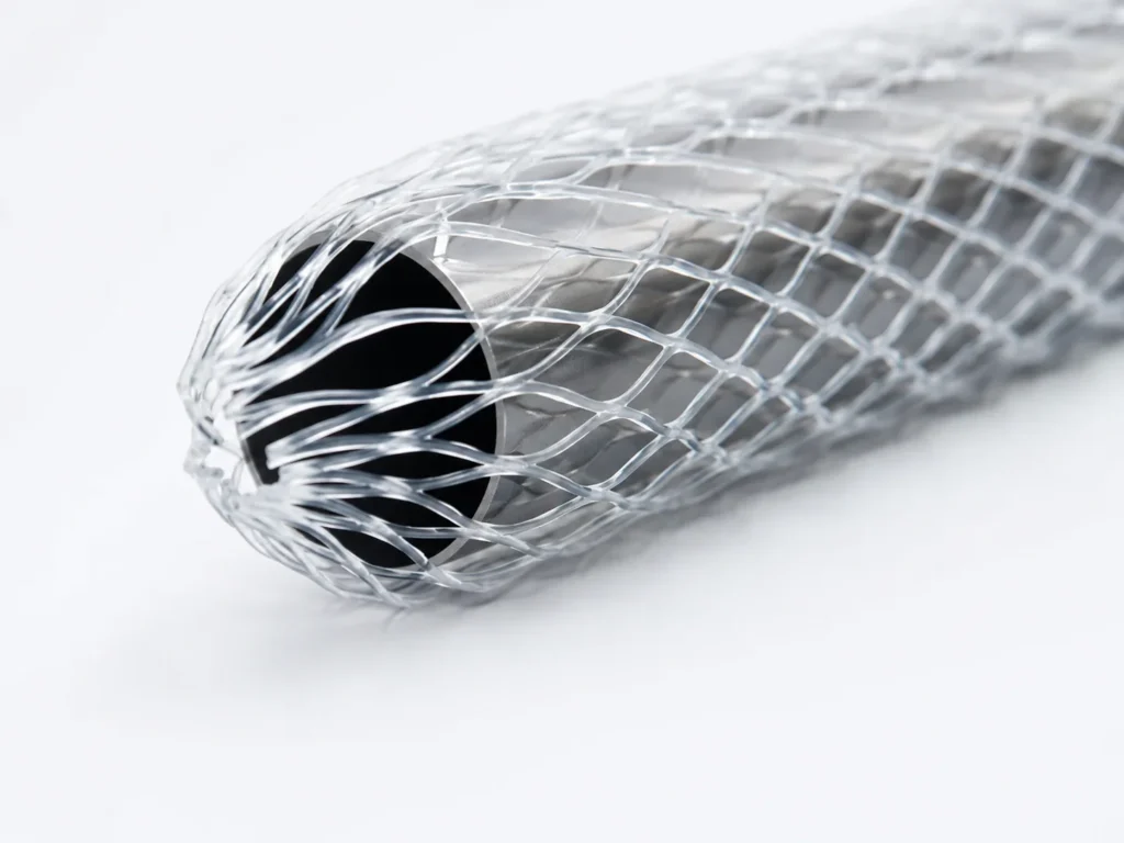 Close-up of a silver wire mesh sleeve wrapped around a dark cylindrical core.